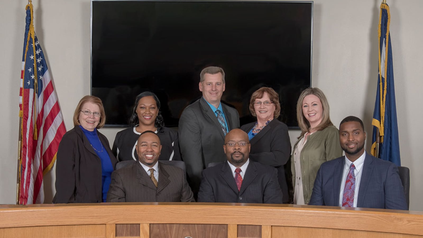 Aurora Public Schools board of directors and Superintendent Rico Munn, center.