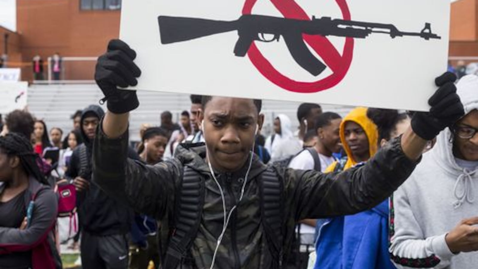 Kyus Carter, a junior at Cordova High School, holds up a sign during a student walkout last year to protest gun violence.