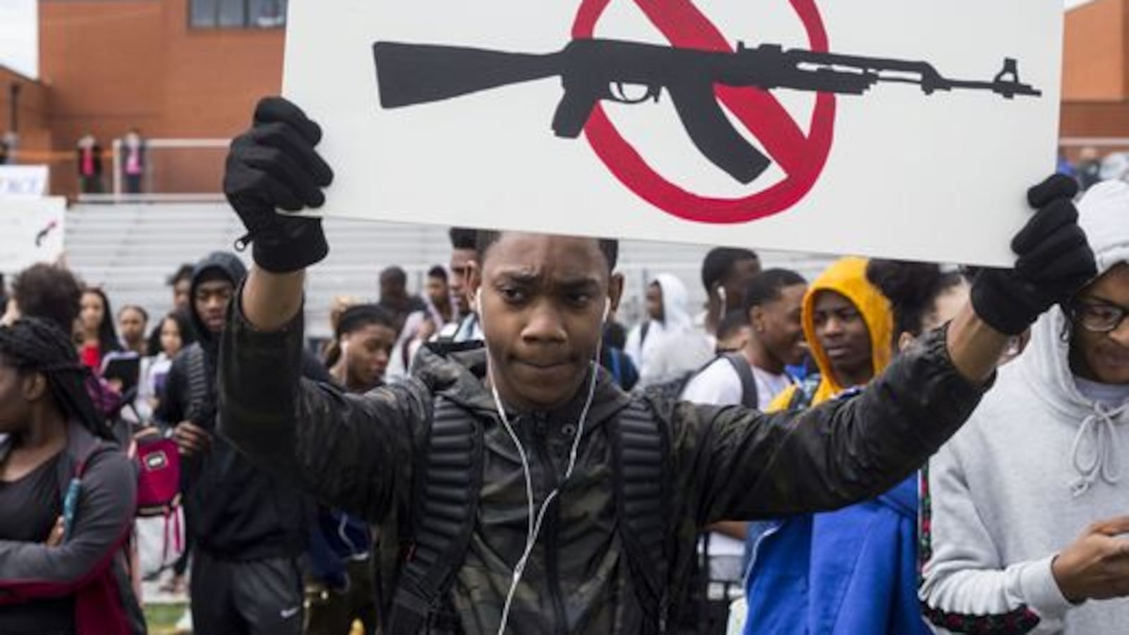 Kyus Carter, a junior at Cordova High School, holds up a sign during a student walkout last year to protest gun violence.