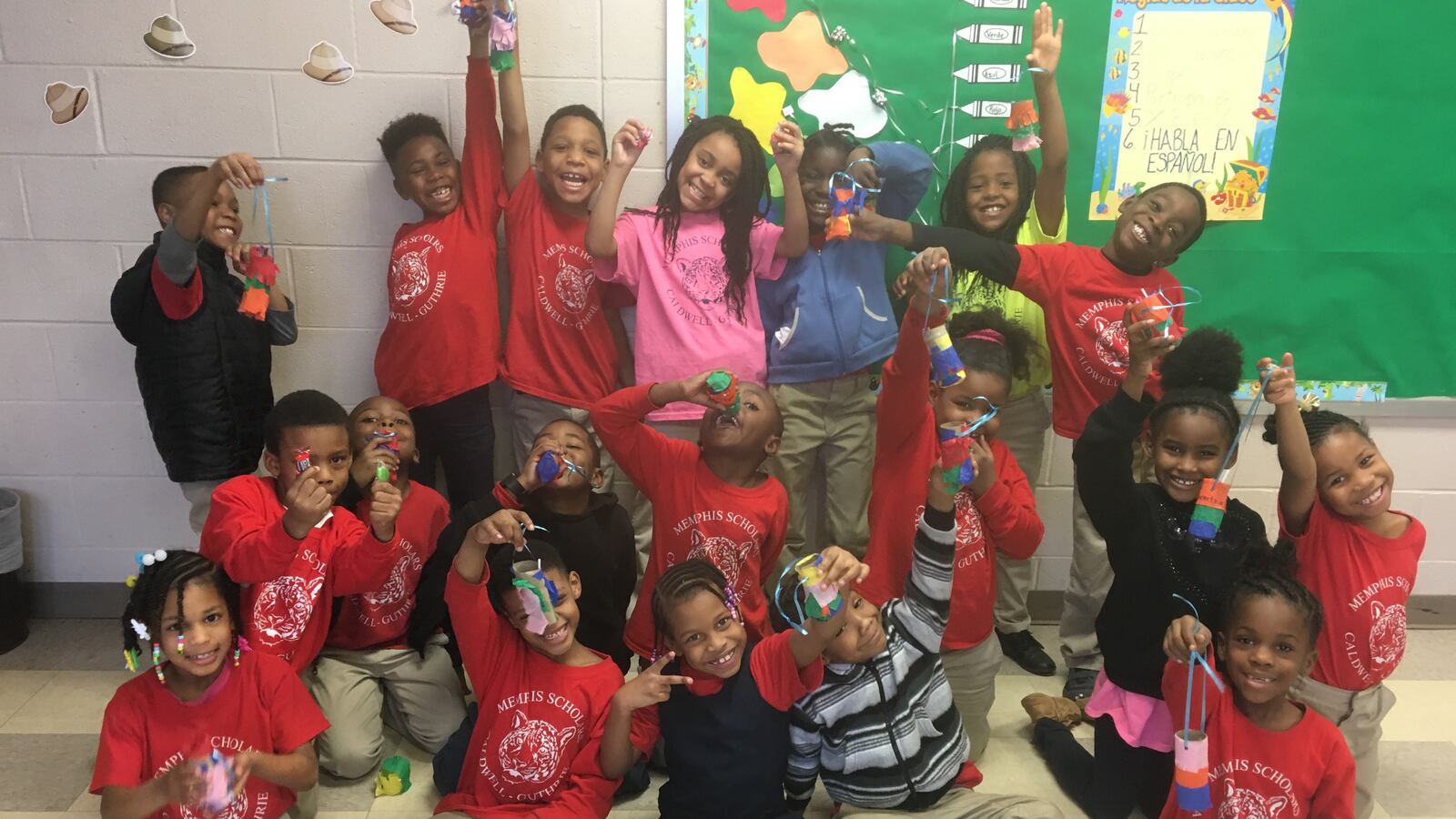 Students show off their homemade piñatas in Kylie Cucalon's Spanish class at Caldwell-Guthrie Elementary, a charter school operated by Memphis Scholars.