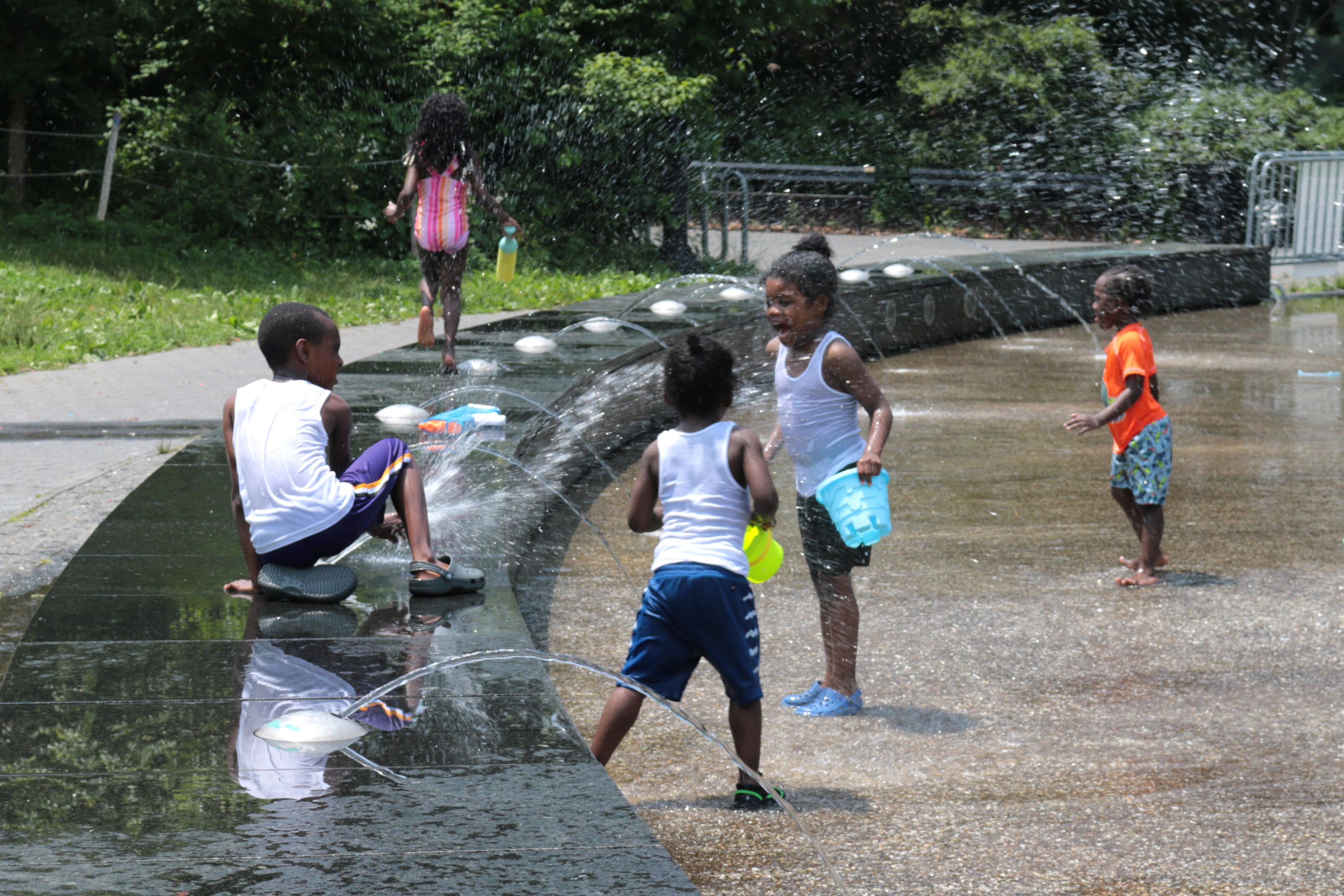 Kids splash around in water.