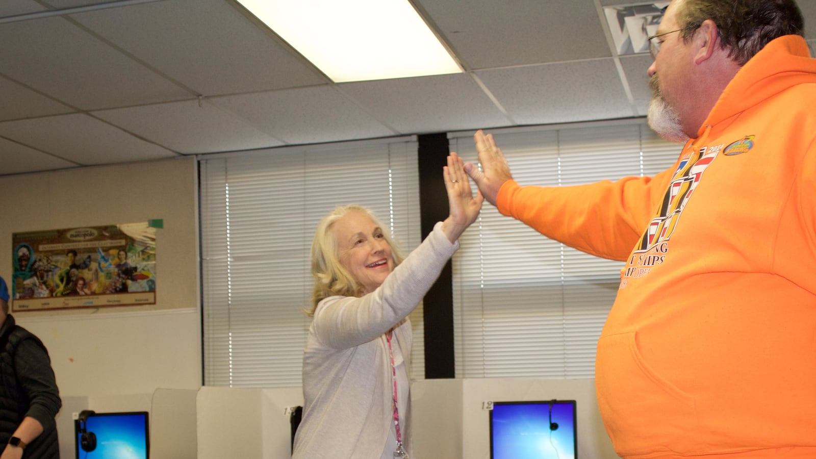 Two teachers high-five during an activity as part of their Beyond Textbooks training at Rose Hill Elementary on April 28, 2017. (Photo by Yesenia Robles, Chalkbeat)