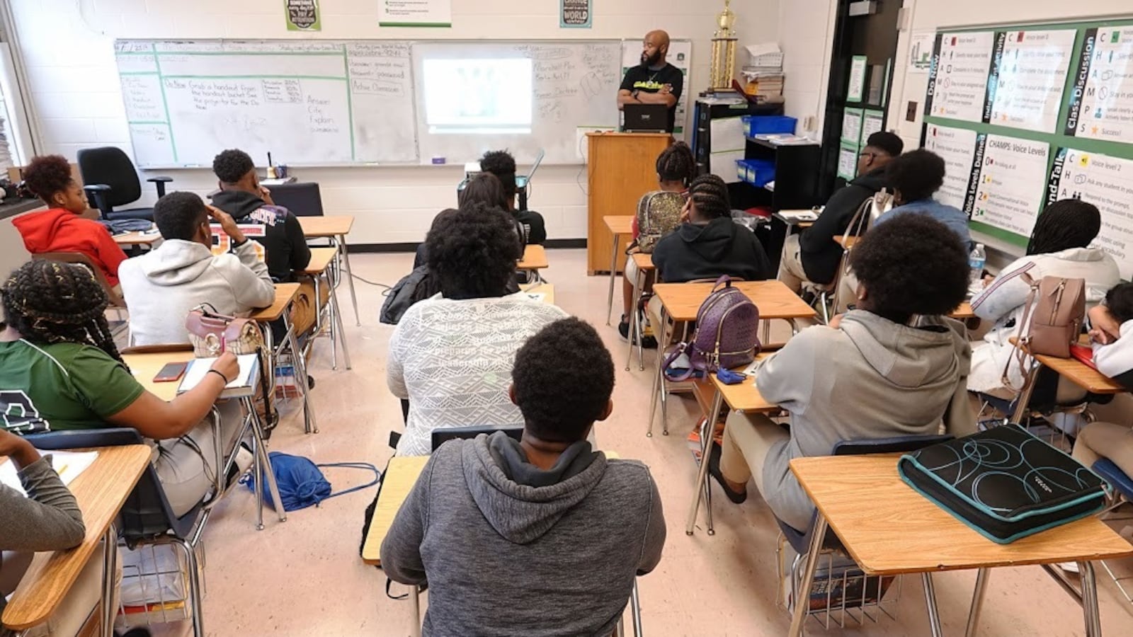 A group of students sit at desks in a classroom.