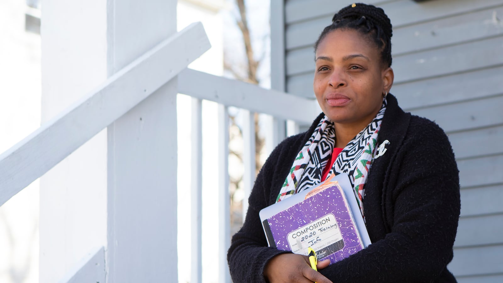 Joicki Floyd poses for a portrait on her porch in Newark.