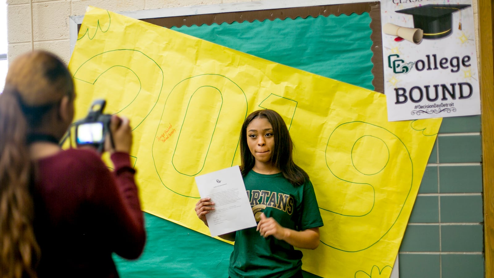 Marqell McClendon, 17, a senior at Cody High School in Detroit, holds up her letter of intent to attend Michigan State University.