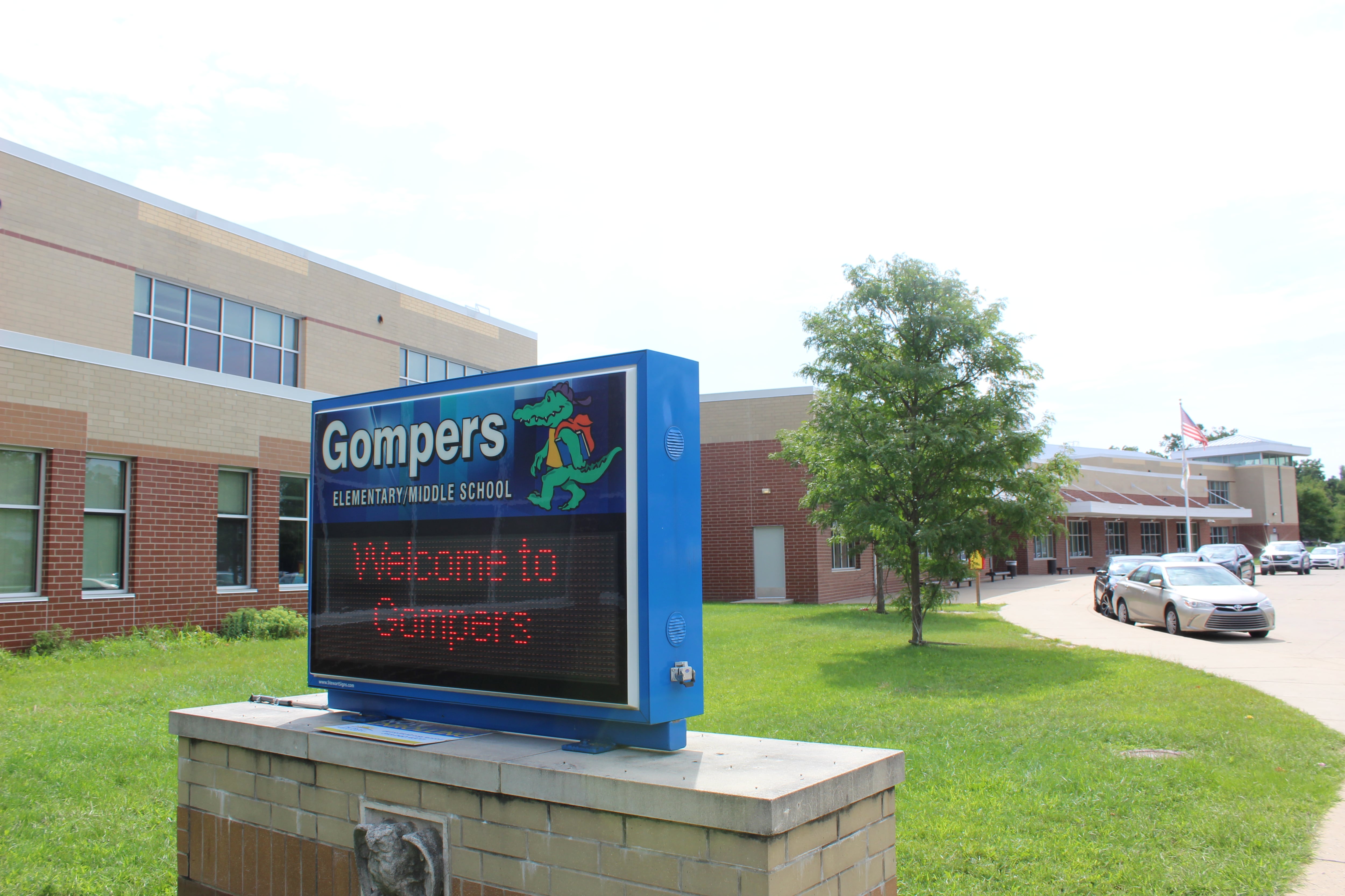A sign in front of a school building.