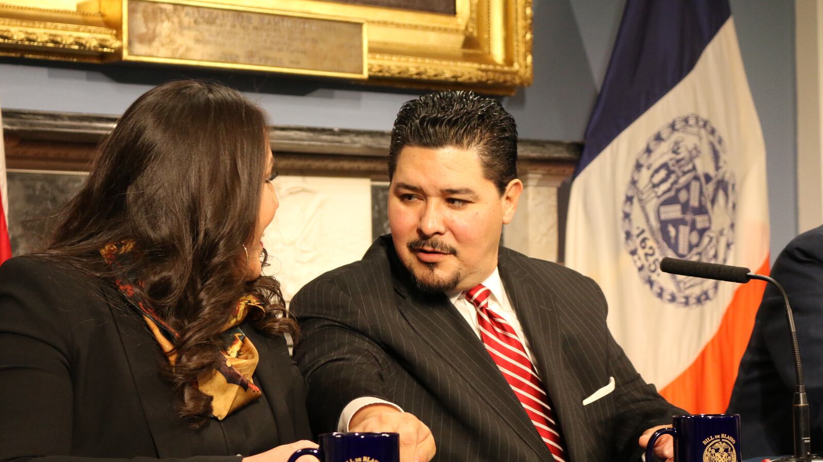 Houston Independent School District Superintendent Richard Carranza, who will become New York City schools chancellor, reaches for his wife's hand.