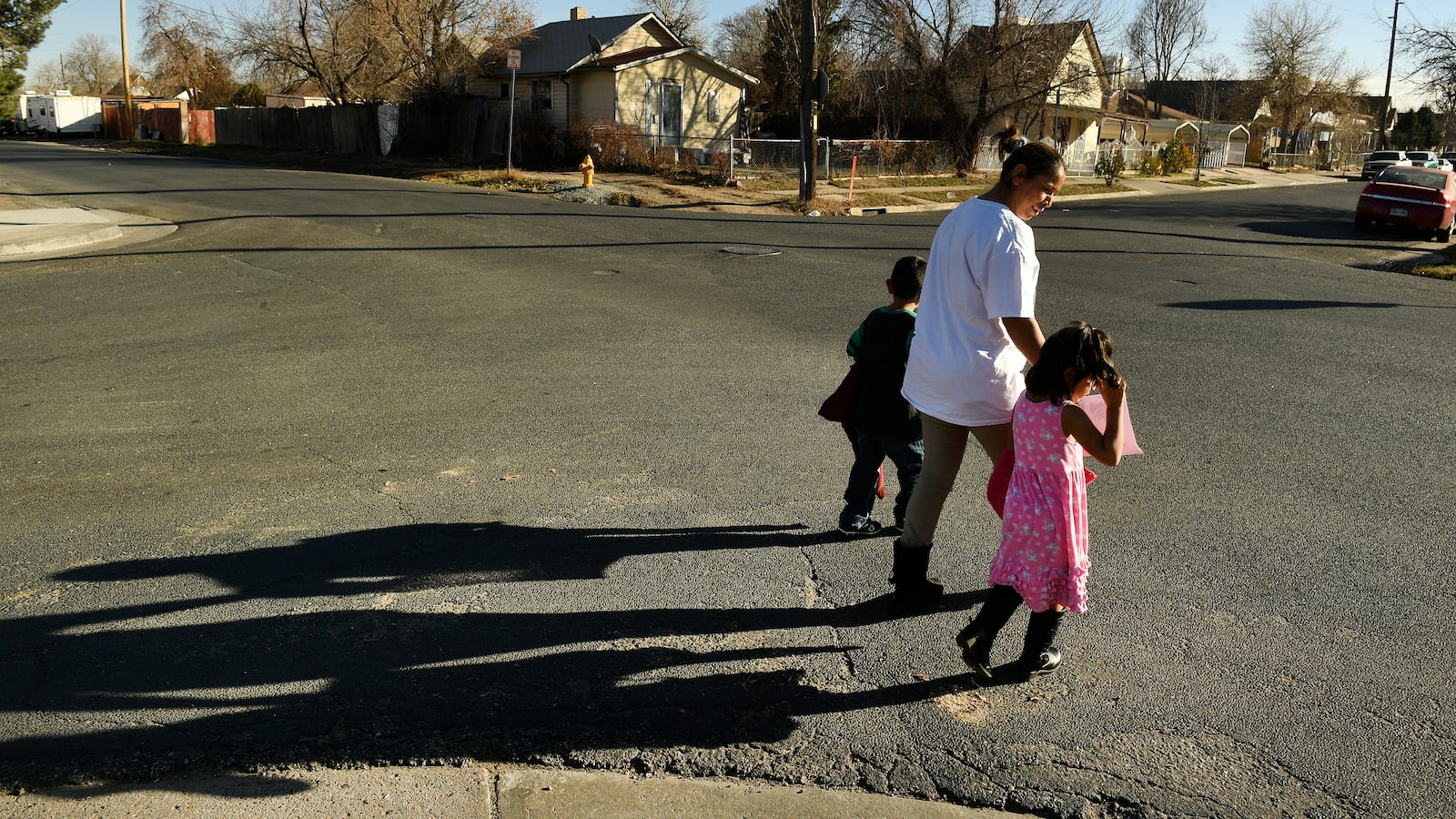Olga Montellano walks with her daughter Milagros Santos, 3, right, and her neighor’s son, Juan Pablo Ordoñez, 3, after preschool in their neighborhood.