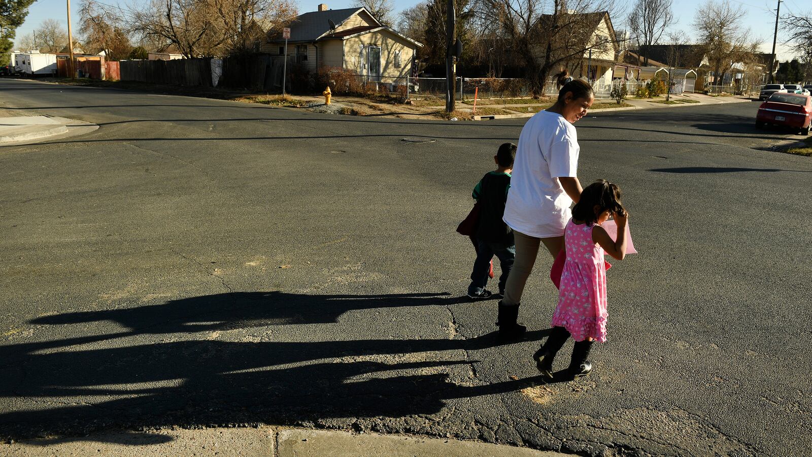 Olga Montellano walks with her daughter Milagros Santos, 3, right, and her neighor’s son, Juan Pablo Ordoñez, 3, after preschool in their neighborhood.