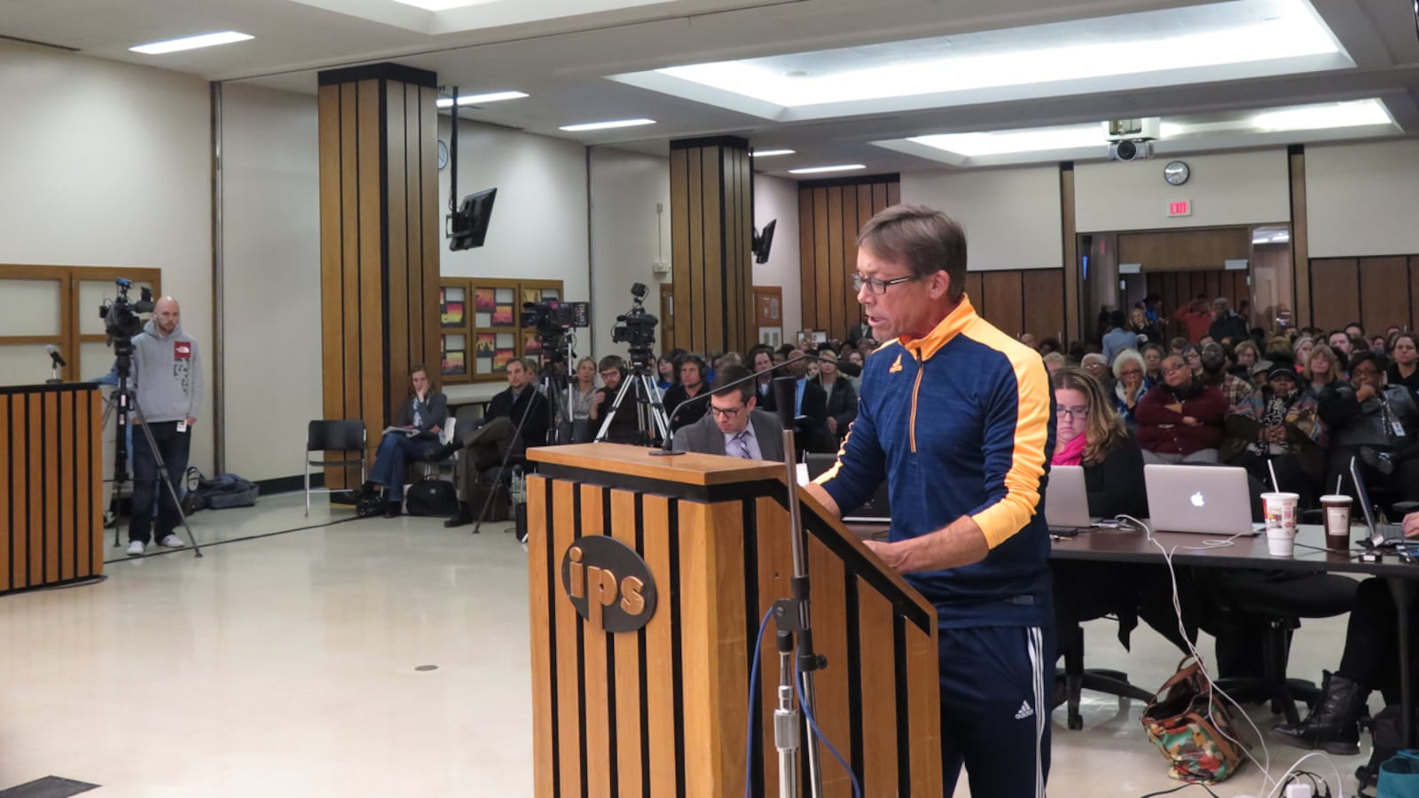 A parent speaks to the Indianapolis Public Schools board of education Tuesday night at a packed meeting on the future of Gambold Prep and Shortridge high schools.