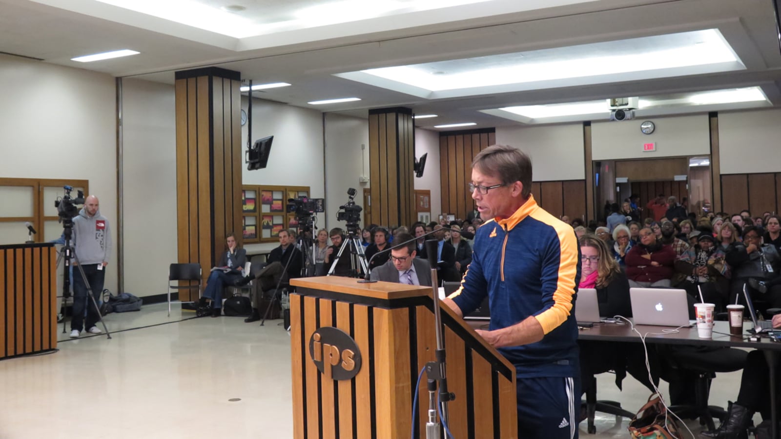 A parent speaks to the Indianapolis Public Schools board of education Tuesday night at a packed meeting on the future of Gambold Prep and Shortridge high schools.