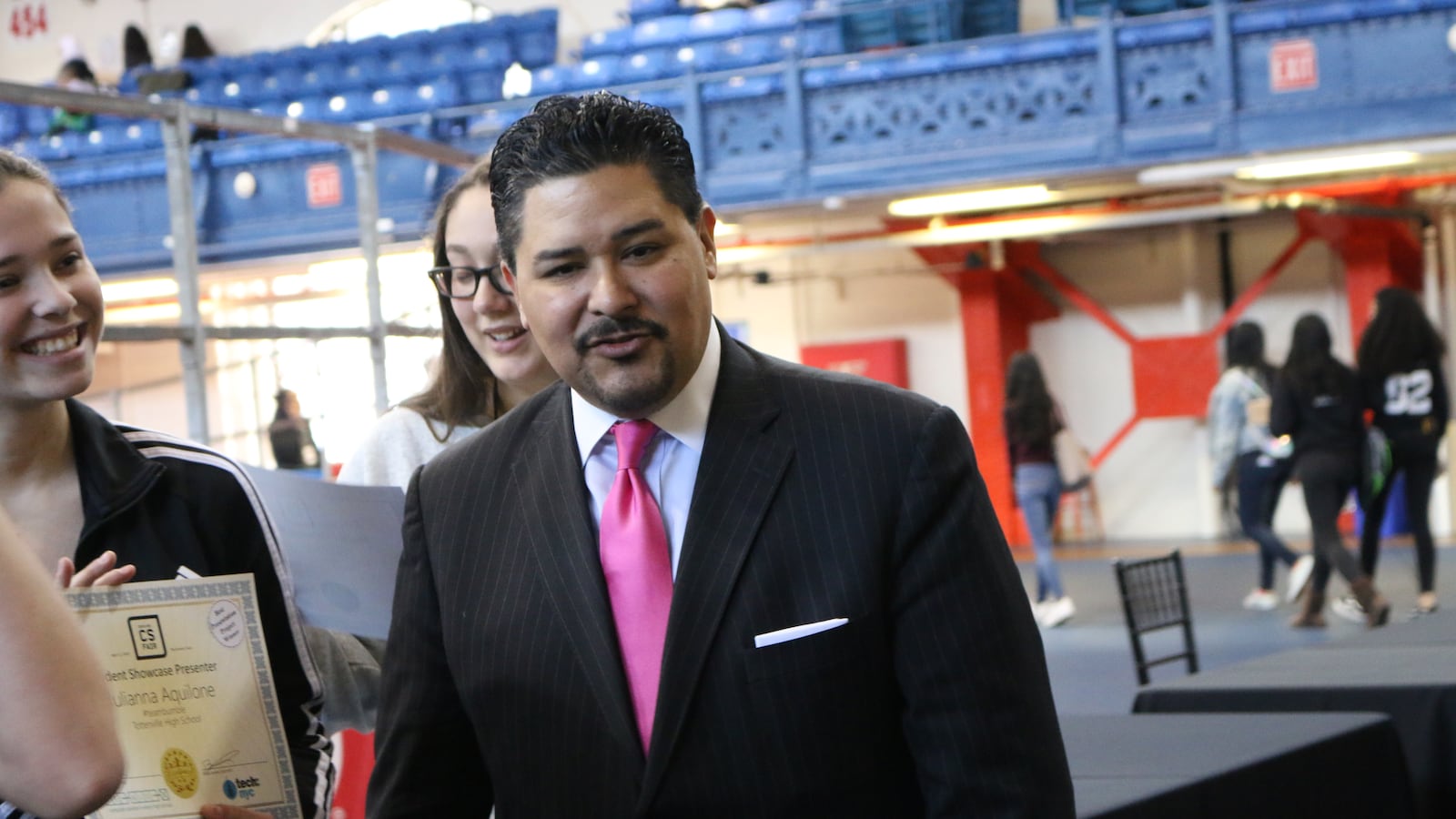 Chancellor Carranza greets students at a computer science fair.