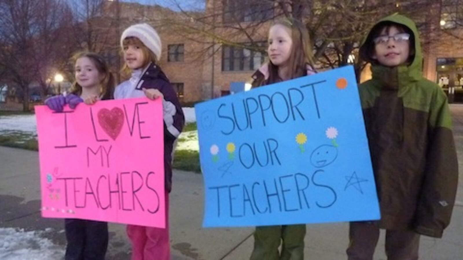 Two of Dougco parent Meredith Massar’s daughters join friends in a protest outside the Douglas County Public Schools administration building.