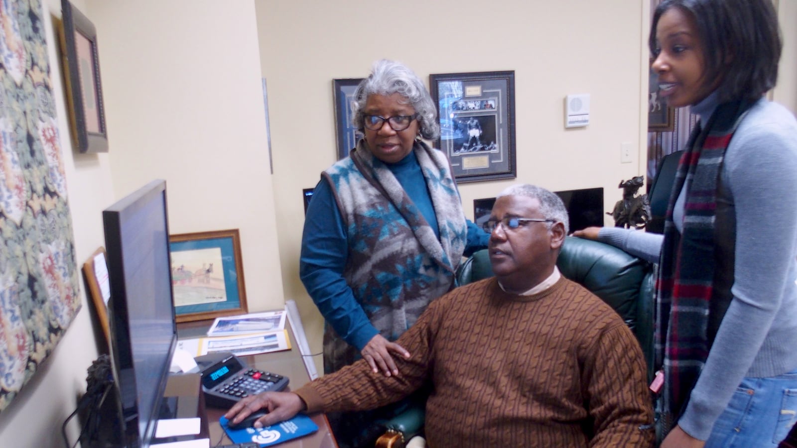 Winston Gipson confers with his wife and daughter, who help run Gipson Mechanical Contractors, a family-owned business in Memphis for 35 years.