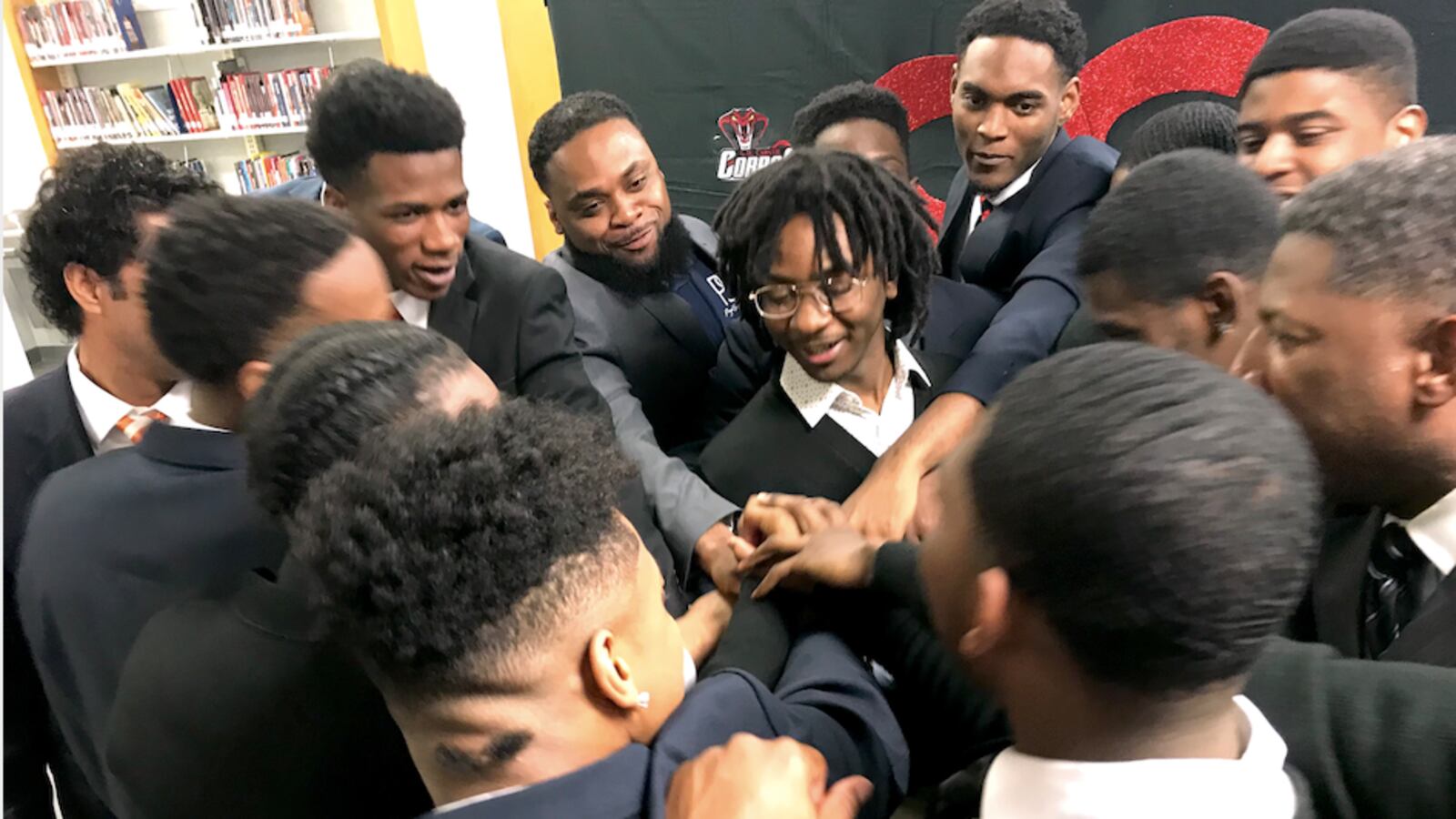 Members of the Brothers & Sisters Speaking Out For Change and their mentors huddle after presenting their recommendations to Shelby County Schools leaders.