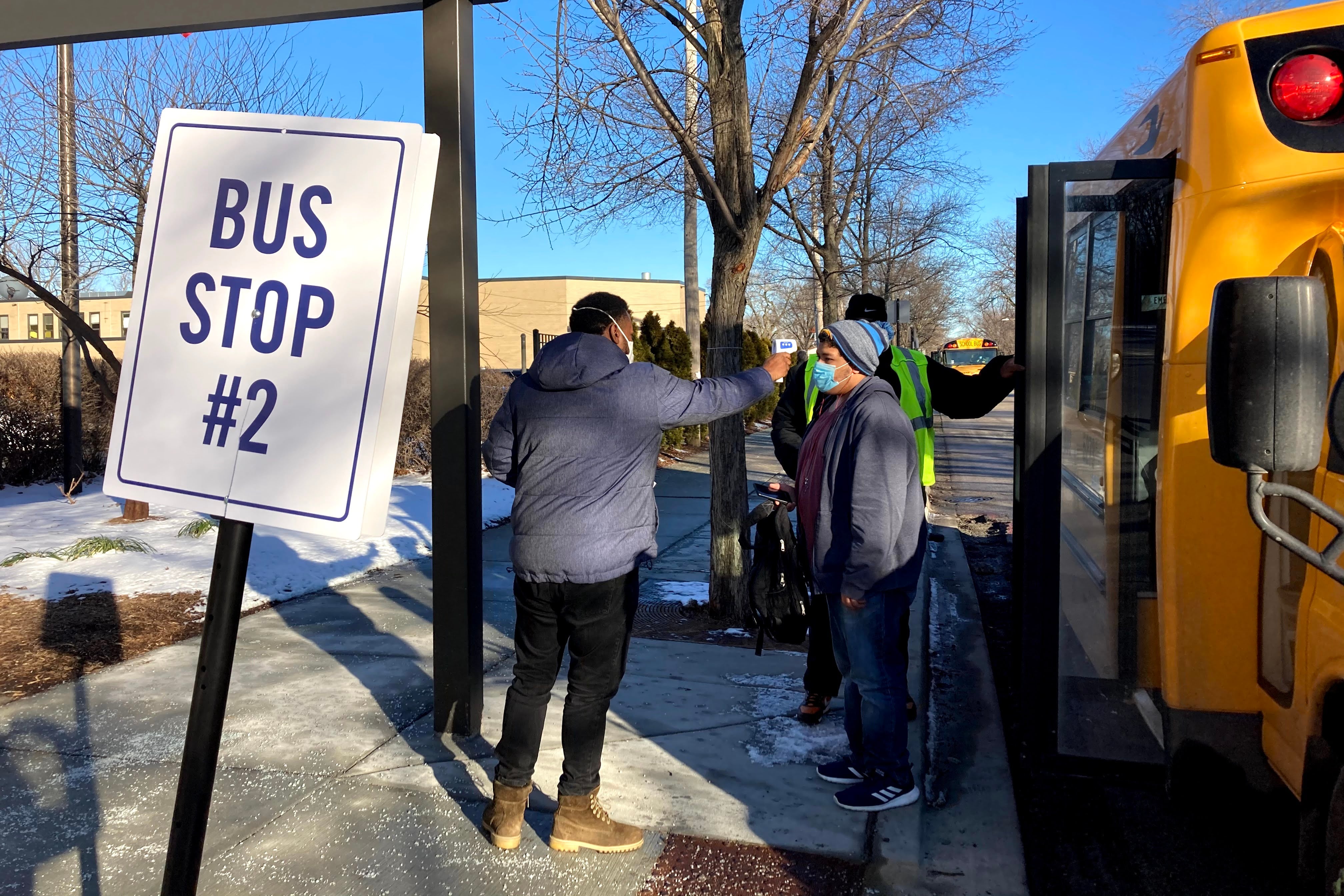 Students exit the bus at Southside Occupational, a Chicago high school for children with disabilities that reopened in the first wave of Chicago’s reopening plan. That plan is now in jeopardy.
