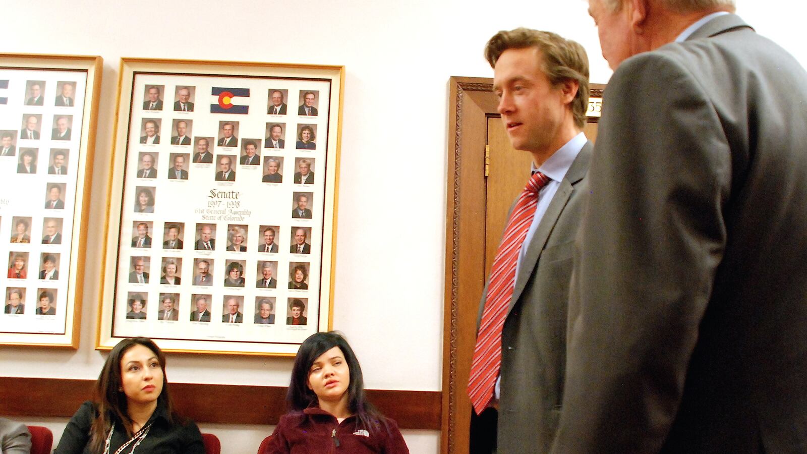 Students from Florence Crittenton High School listen to state Sen. Mike Johnston as Sen. Larry Crowder stands by.