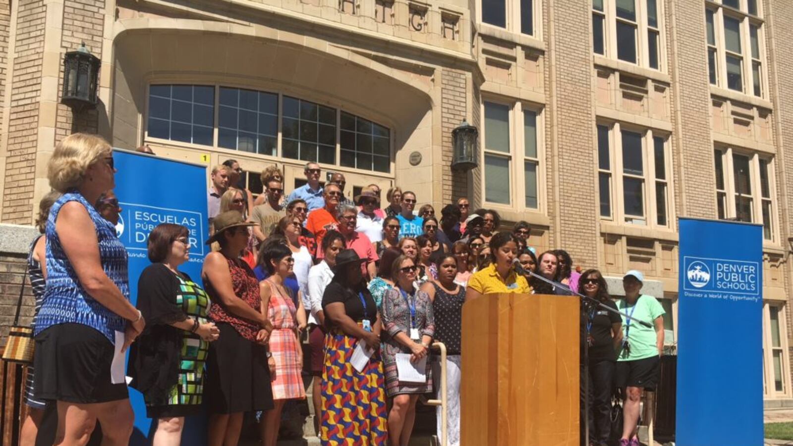 Flanked by principals and fellow board members, Angela Cobián denounces the impact of family separation on students at a press conference at West High School. (Erica Meltzer/Chalkbeat)