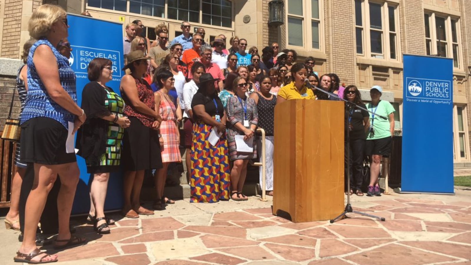 Flanked by principals and fellow board members, Angela Cobián denounces the impact of family separation on students at a press conference at West High School. (Erica Meltzer/Chalkbeat)