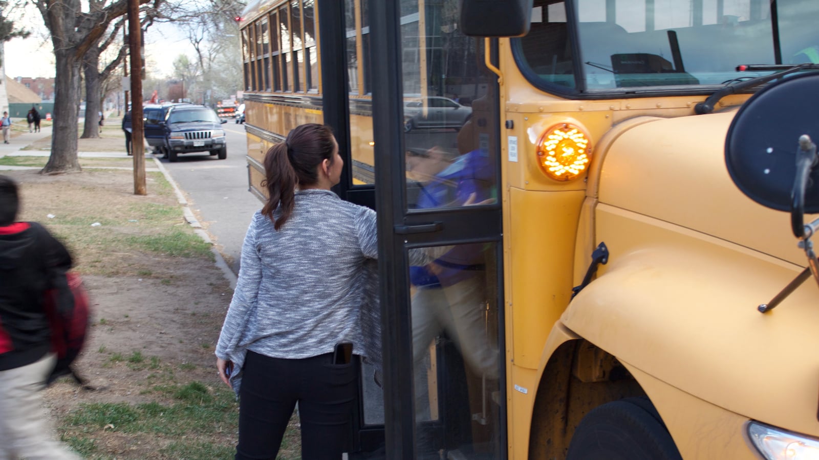 School officials help students getting off the Success Express buses at University Prep in Denver last week.