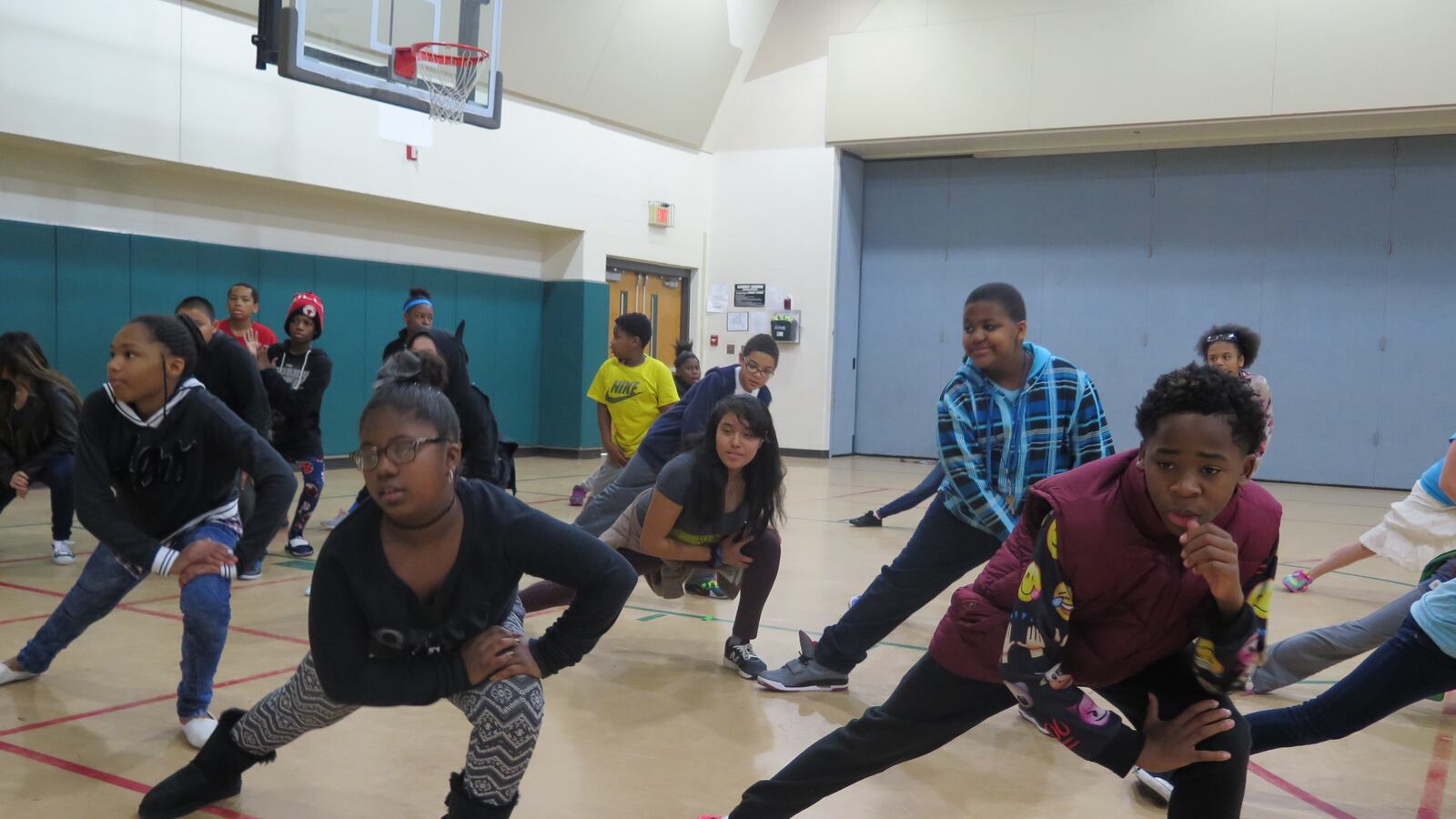 Students at Harrison Hill Elementary School warm up during dance class.