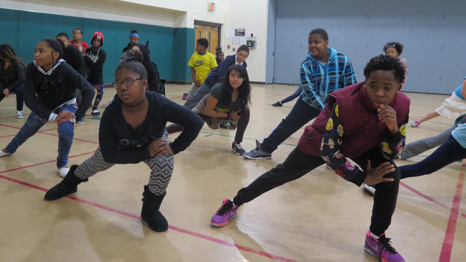Students at Harrison Hill Elementary School warm up during dance class.