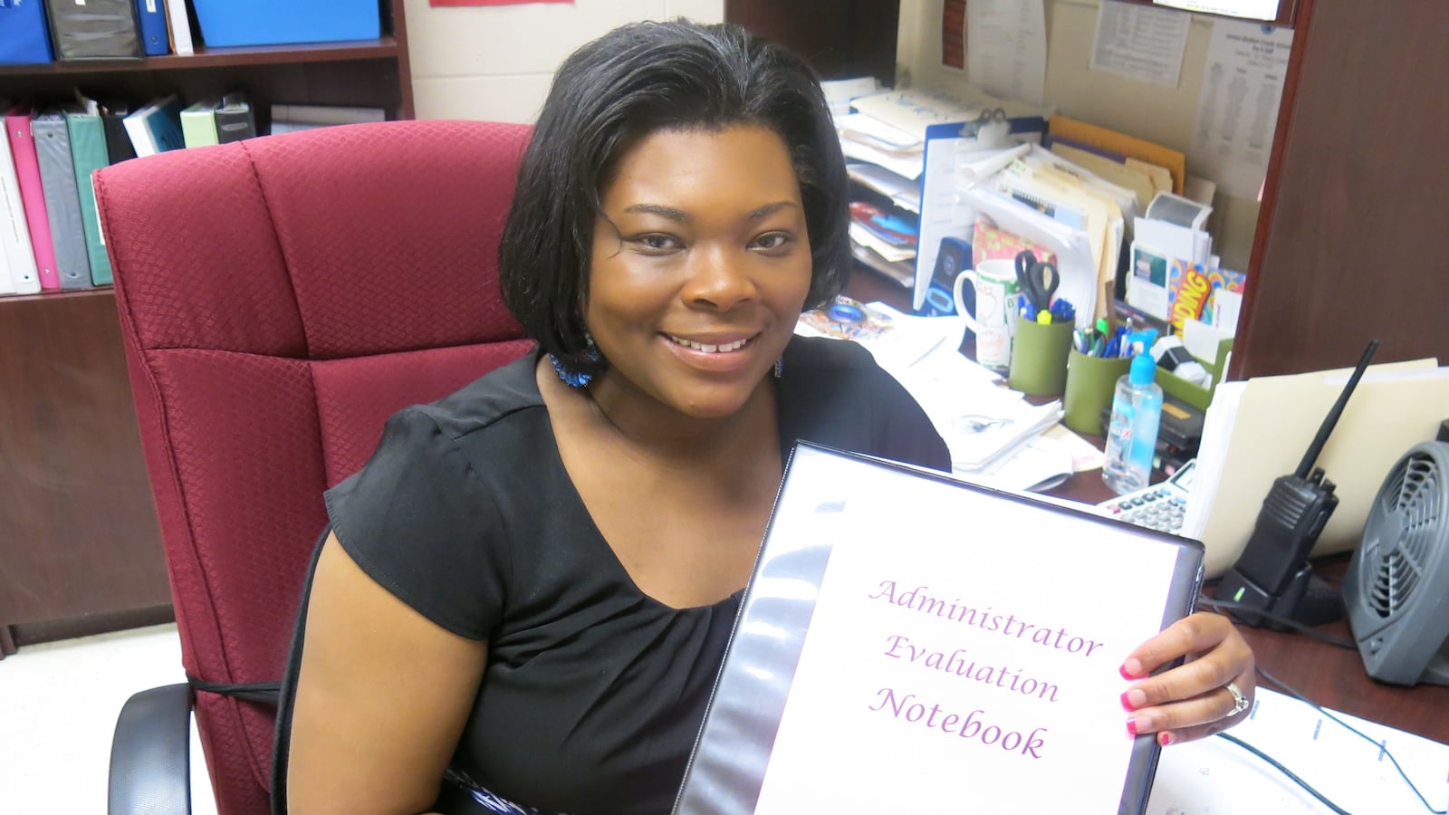 Jackson-Madison County School Principal Tiffany Green holds her Administration Evaluation Notebook, which is used during her principal observation periods.