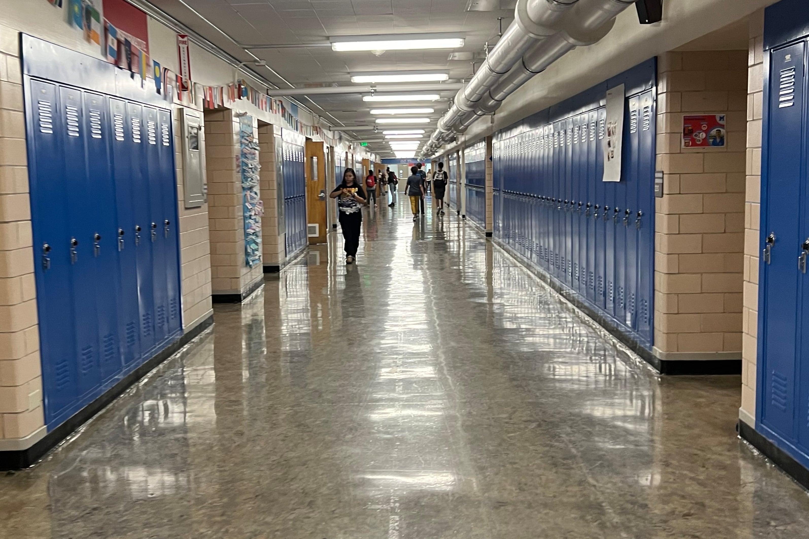 Blue lockers in a school hallway.