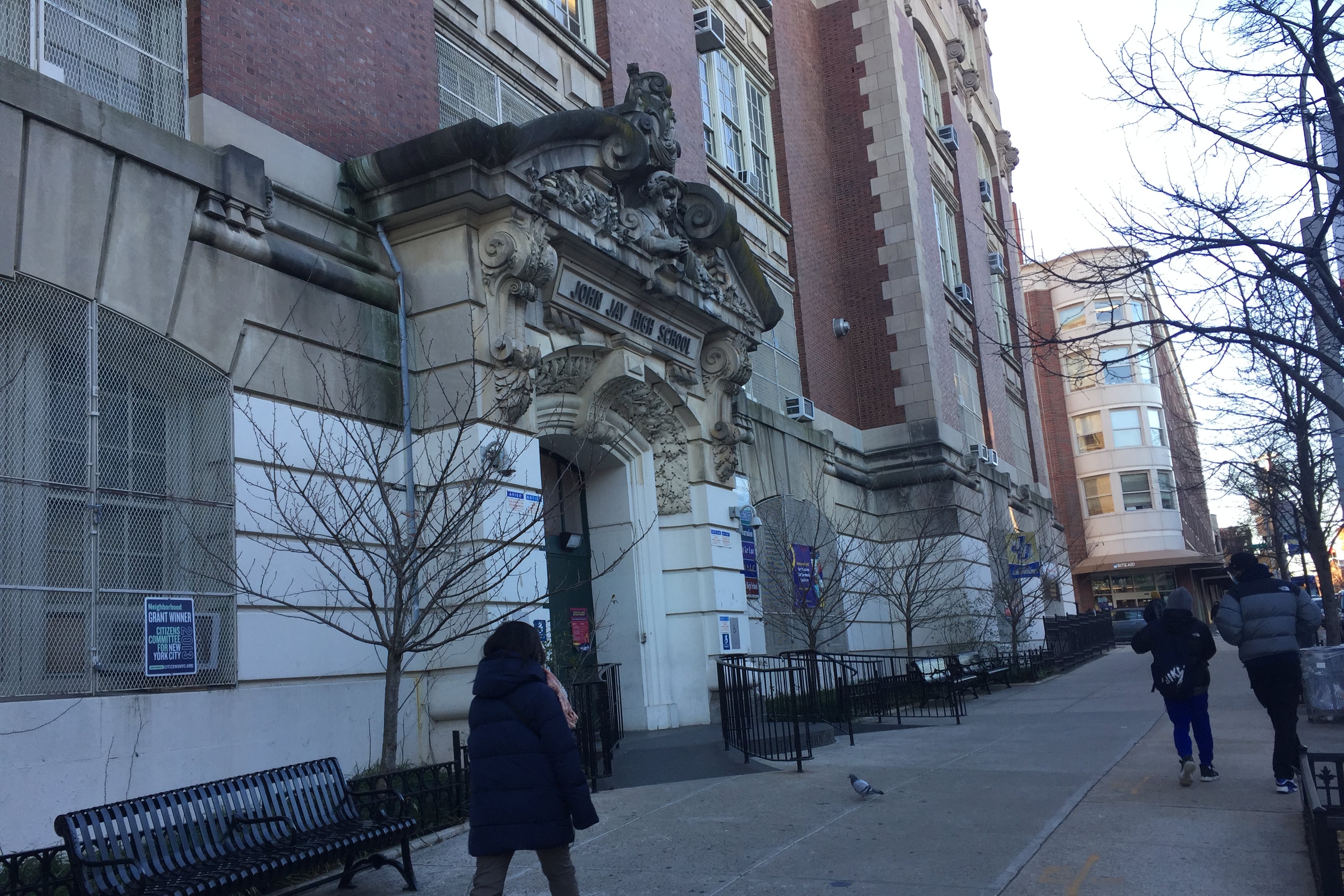 A student walks in front of a Brooklyn public school building.
