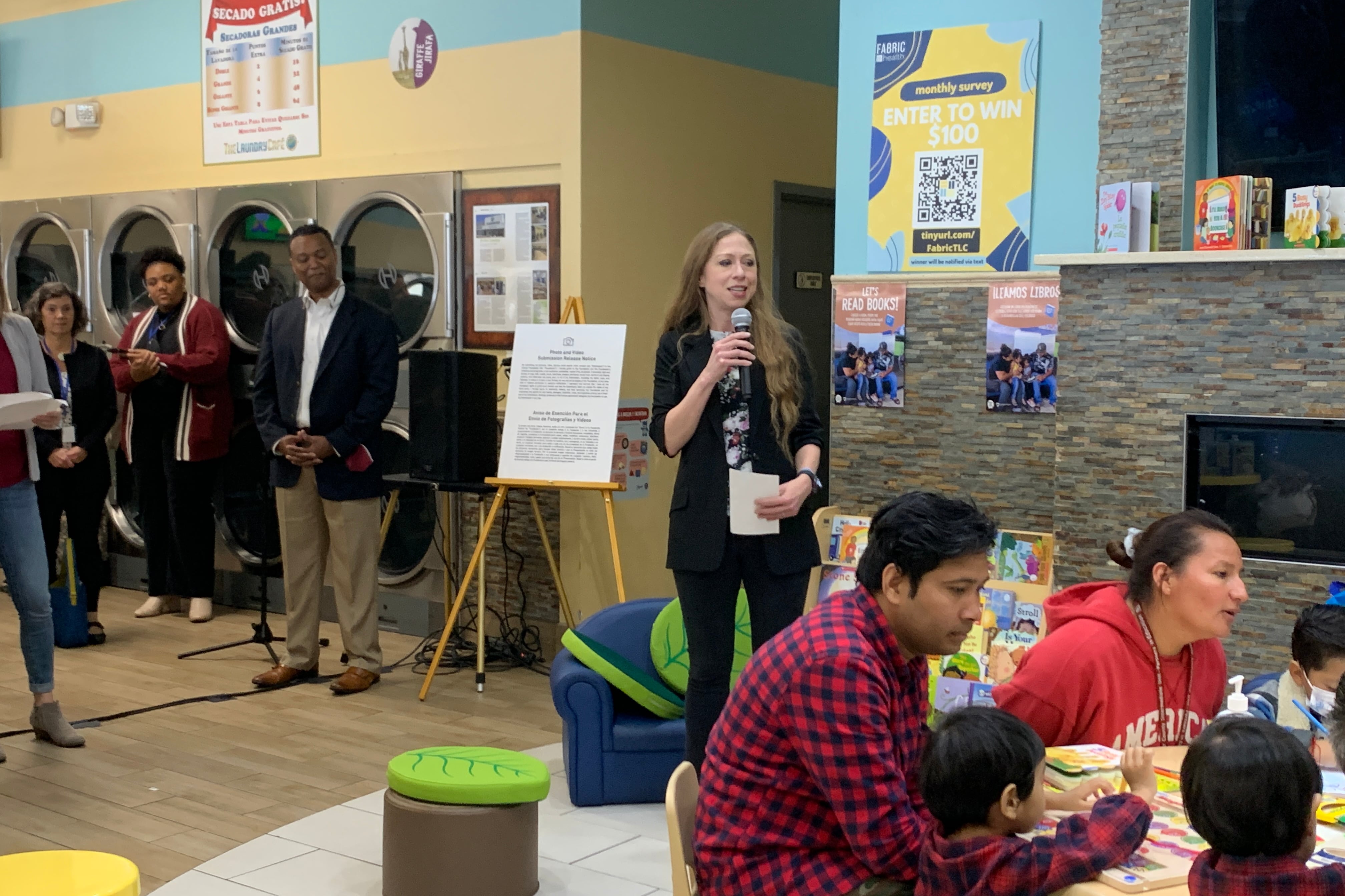 Chelsea Clinton with a crowd of people in a laundromat in Philadelphia