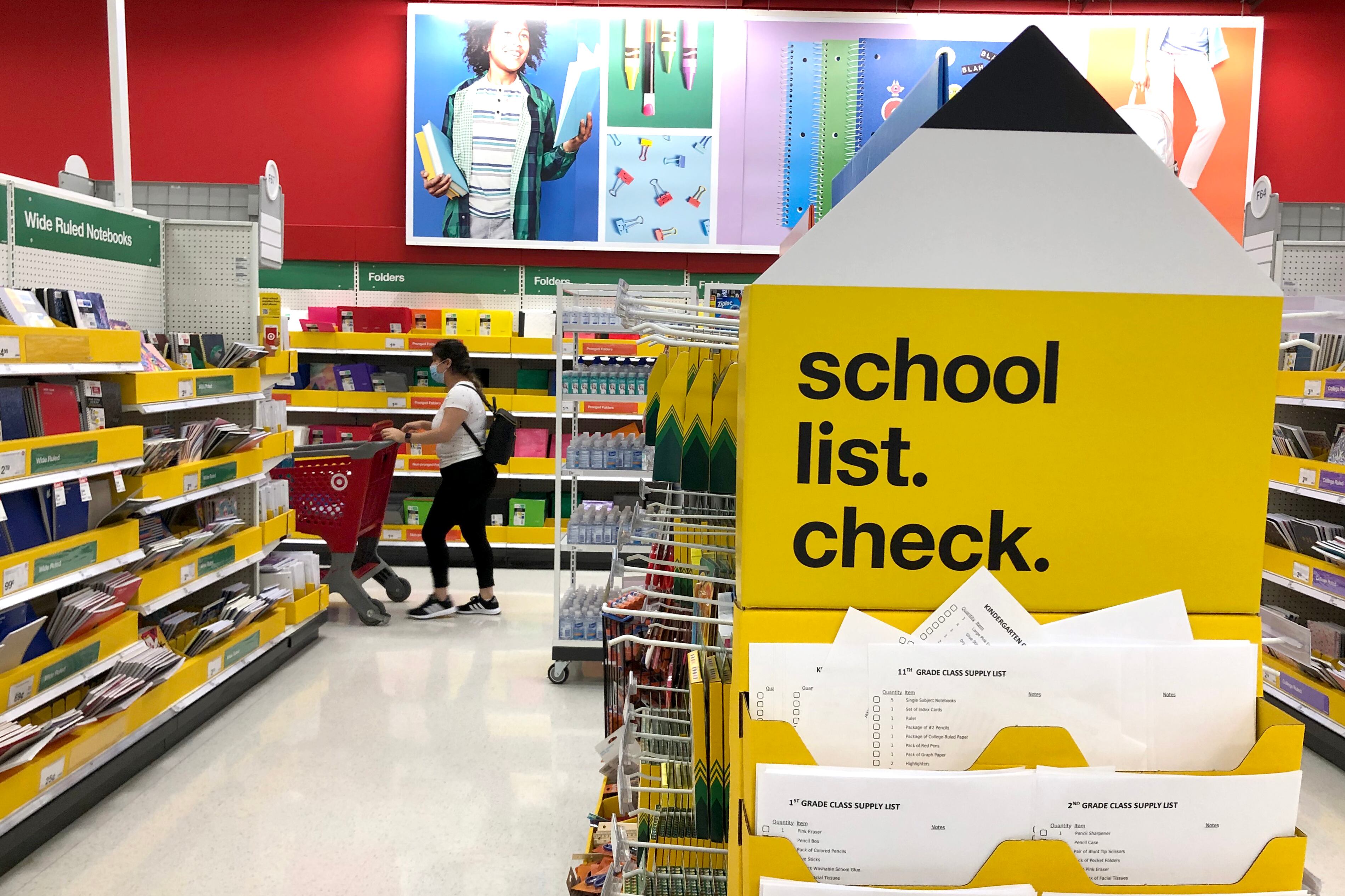 A school-supply aisle in a department store with a sign that says “school list: check”