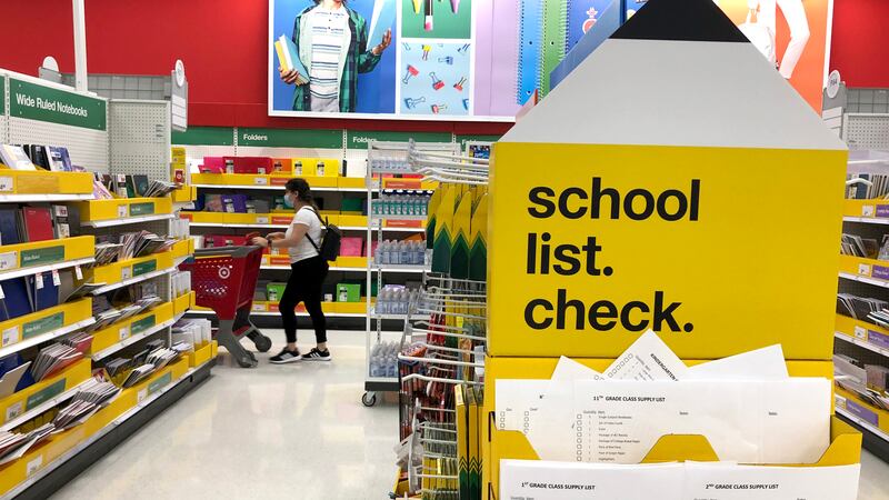 A school-supply aisle in a department store with a sign that says “school list: check”