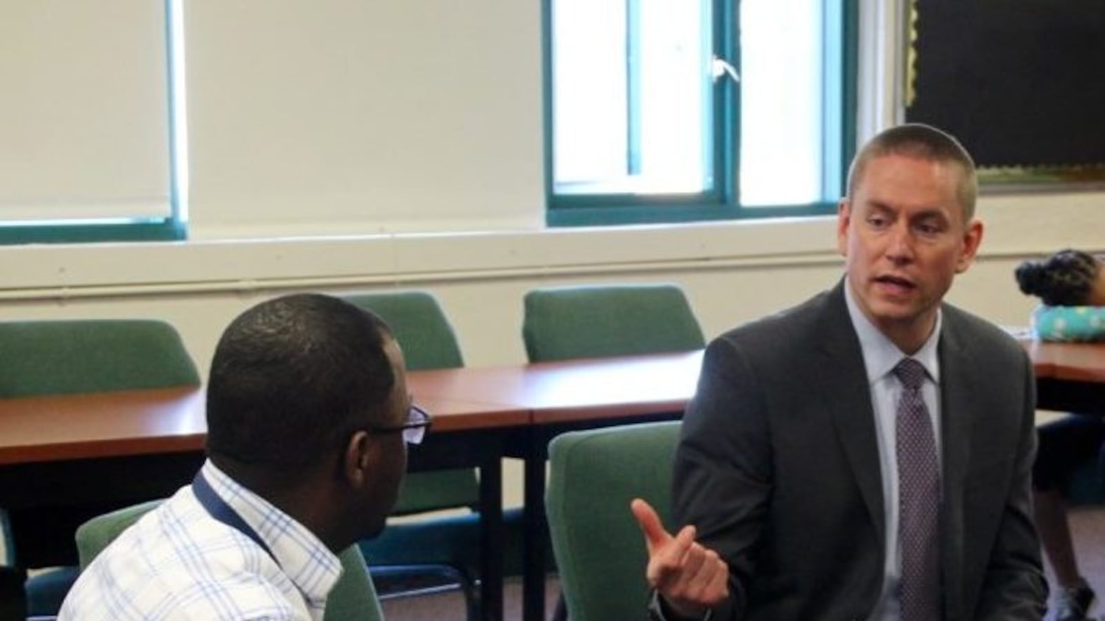 Stephen Osborn (right), a finalist for superintendent of Tennessee's Achievement Schools District, speaks with Mendell Grinter, leader of the Campaign for School Equity, during a meeting at Martin Luther King College Preparatory School in Memphis.
