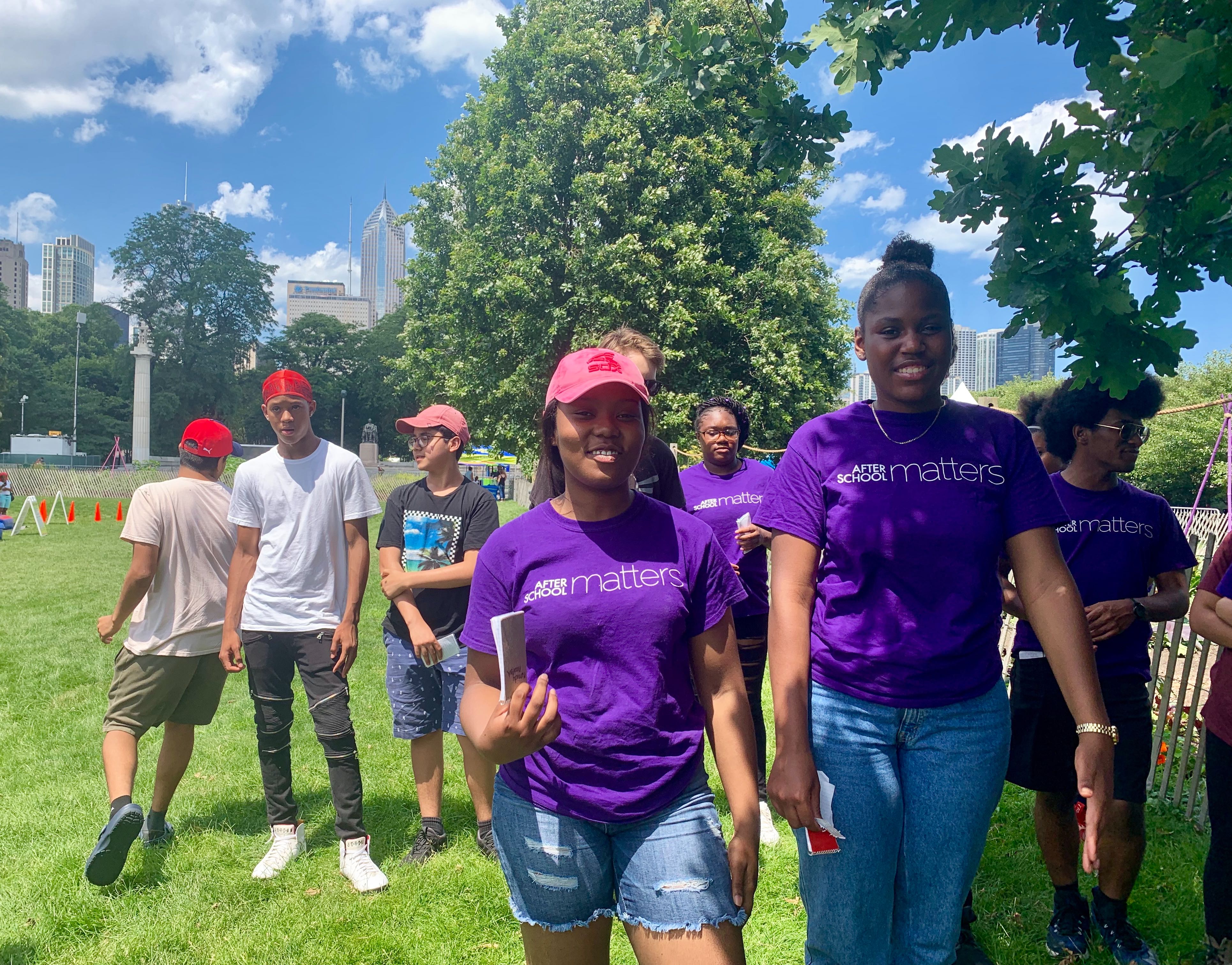 Kennedy Woodfork, left, and Alyssa Goodwin, participating in a summer program with the the Urban Grower’s Collective, lead a tour of their community garden in Grant Park on July 10.