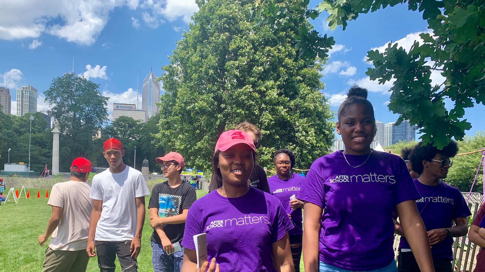 Kennedy Woodfork, left, and Alyssa Goodwin, participating in a summer program with the the Urban Grower’s Collective, lead a tour of their community garden in Grant Park on July 10.