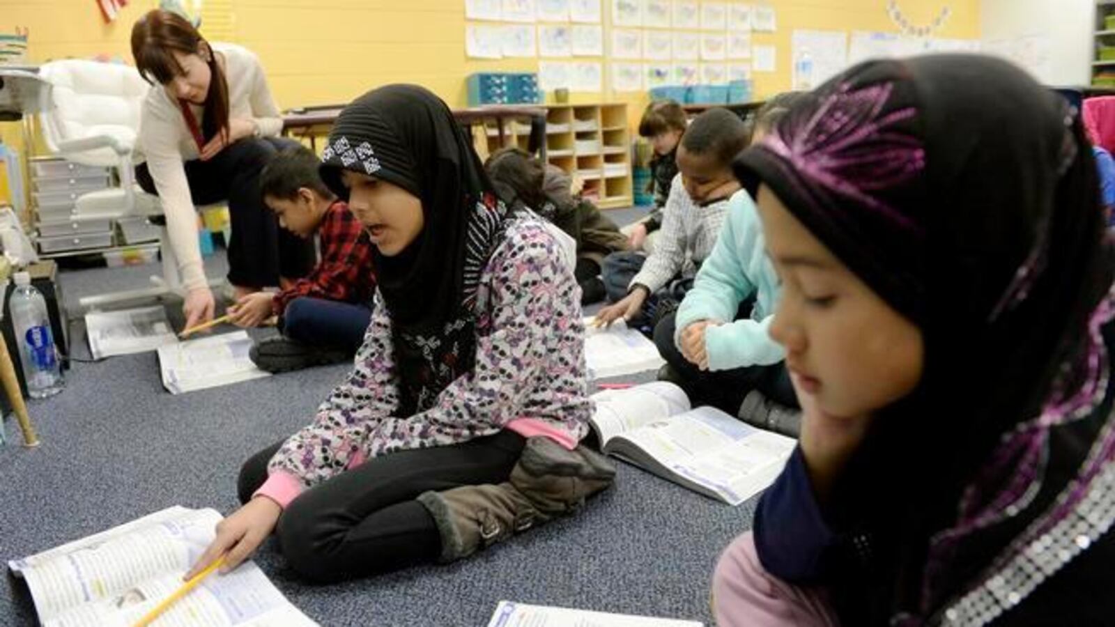 Louise Kreuzer, top left, teaches third-graders in a newcomer classroom at Place Bridge Academy in Denver.