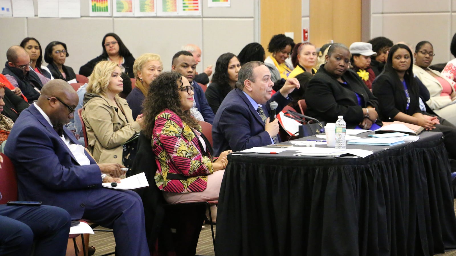 Superintendent Roger León, center, received recommendations for his district plan this week.