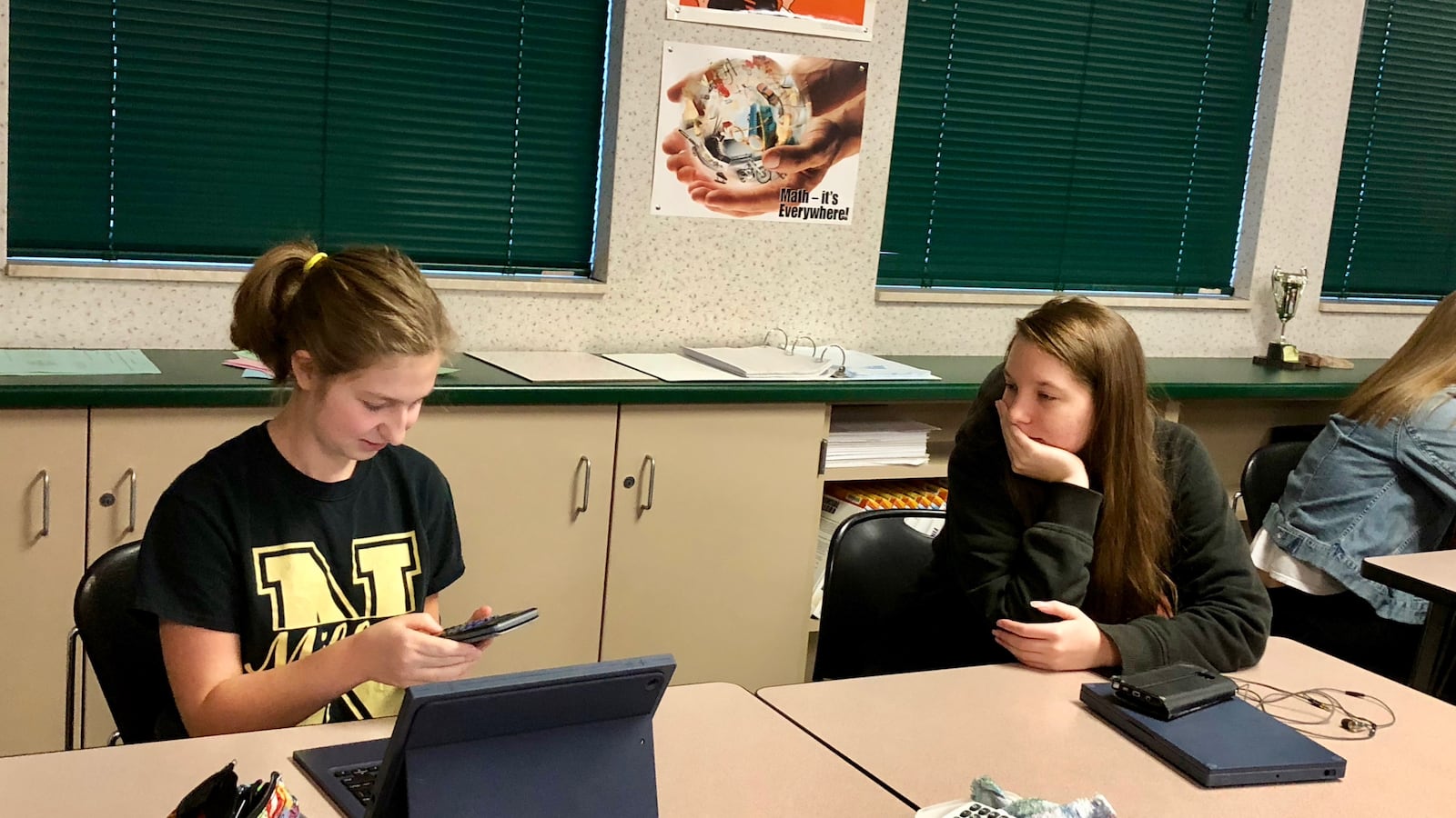 Two Noblesville High School students work through a project related to texting and driving for their financial Algebra 2 class.