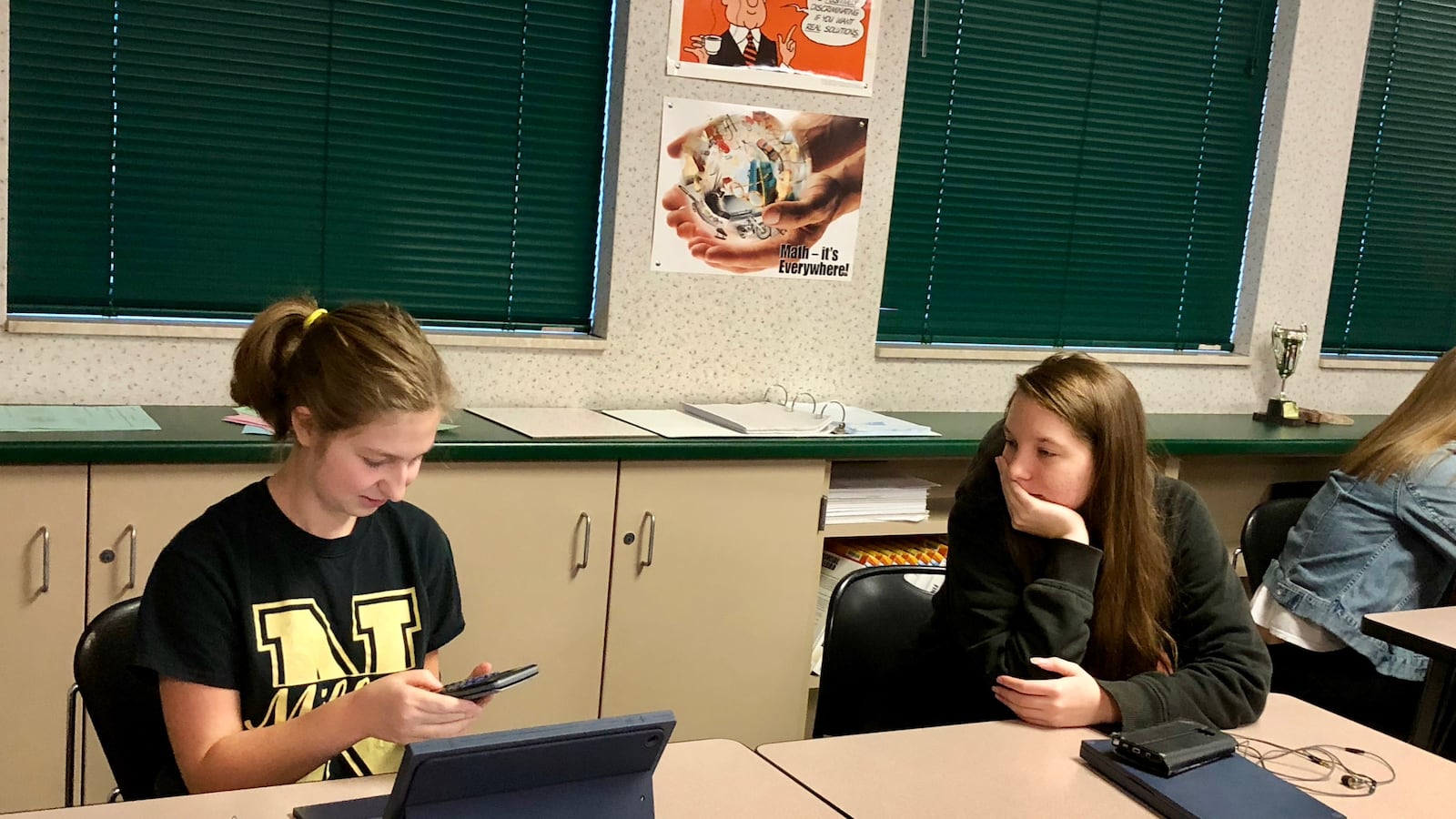 Two Noblesville High School students work through a project related to texting and driving for their financial Algebra 2 class.