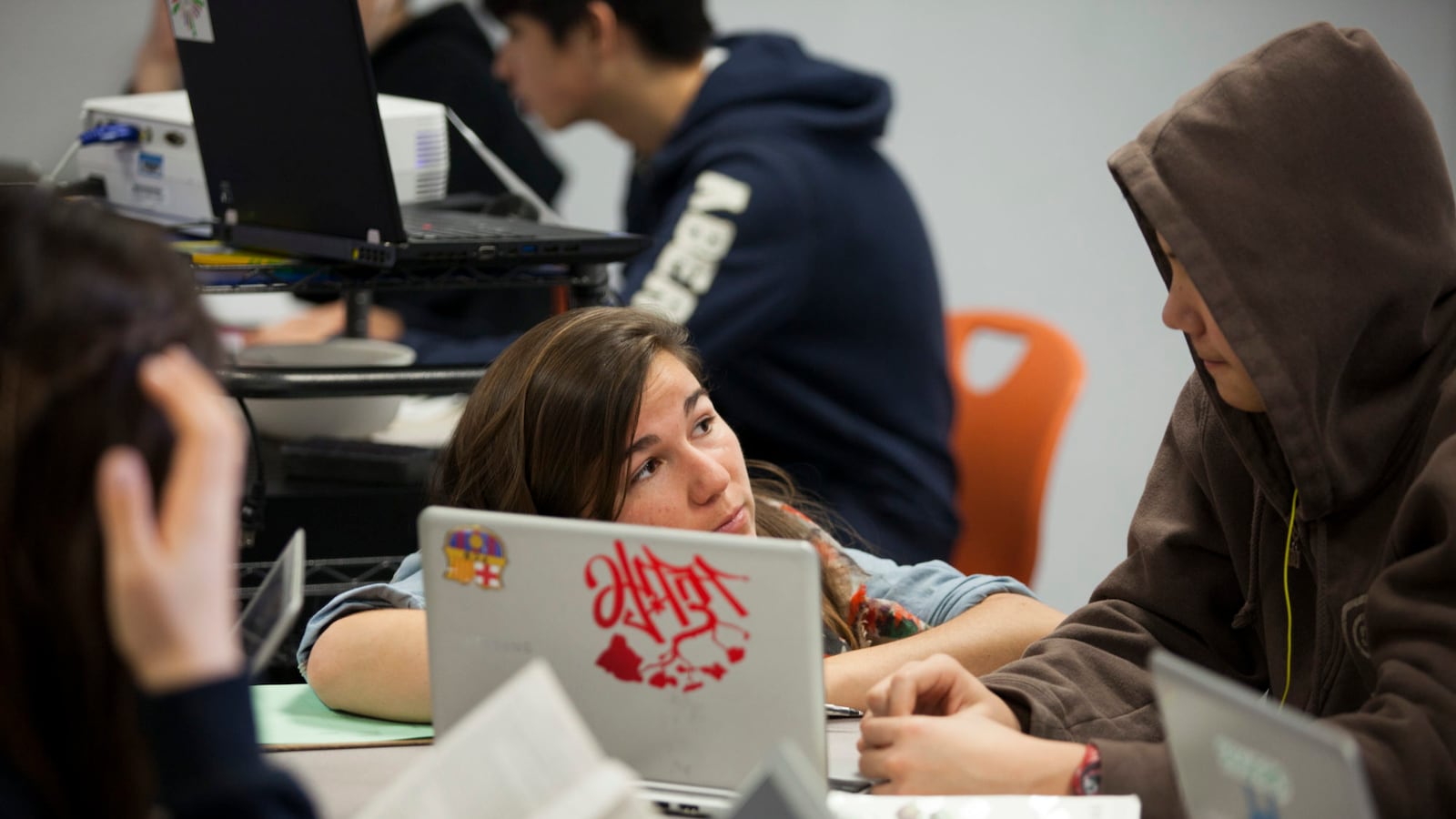 English teacher Adelaide Giornelli works with ninth grade students on computers at Shasta charter public high school, part of the Summit public school system. (Photo by Melanie Stetson Freeman/The Christian Science Monitor via Getty Images)