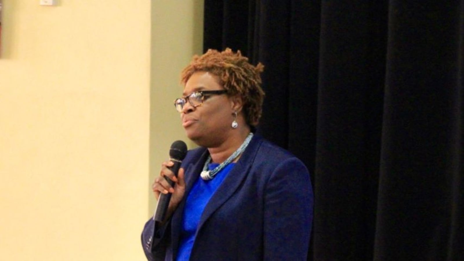 Yetta Lewis, co-founder and CEO of Gestalt Community Schools, answers questions from parents and teachers during an October assembly at Humes Preparatory Academy Middle School.