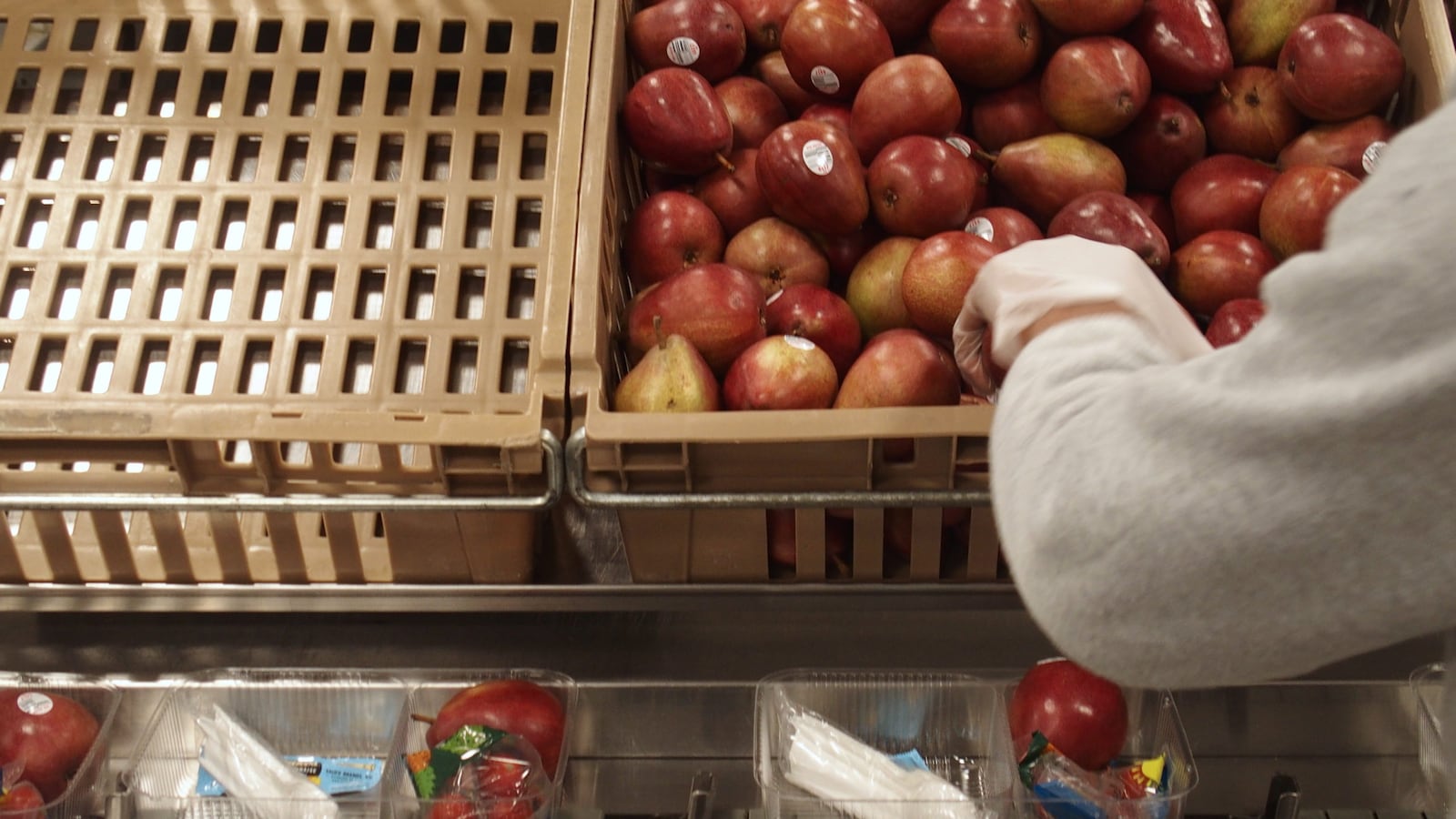 Shelby County Schools staff prepare to-go lunches for students while school is closed over concerns of the new coronavirus spreading. The district is no longer handling the meal distribution after a nutrition services employee tested positive for COVID-19.