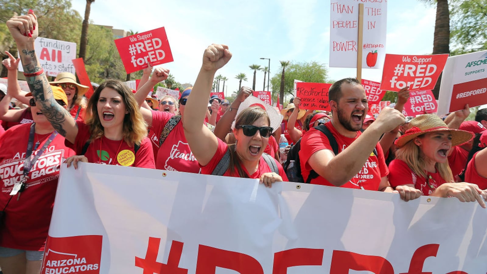 Arizona teachers chant in support of the #REDforED movement as they walk through downtown Phoenix  to the State Capitol on April 26, 2018. The walkout sought better wages and state funding for public schools. Its leaders are talking with teachers in Tennessee about how they can organize in a similar fashion. (Photo by Ralph Freso/Getty Images)