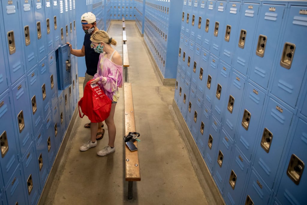 Senior Mason Wise, left, helps his sister Mackenzie, a sophomore, clean out her PE locker at El Camino Real Charter High School on April 30, 2020 in Woodland Hills, California.