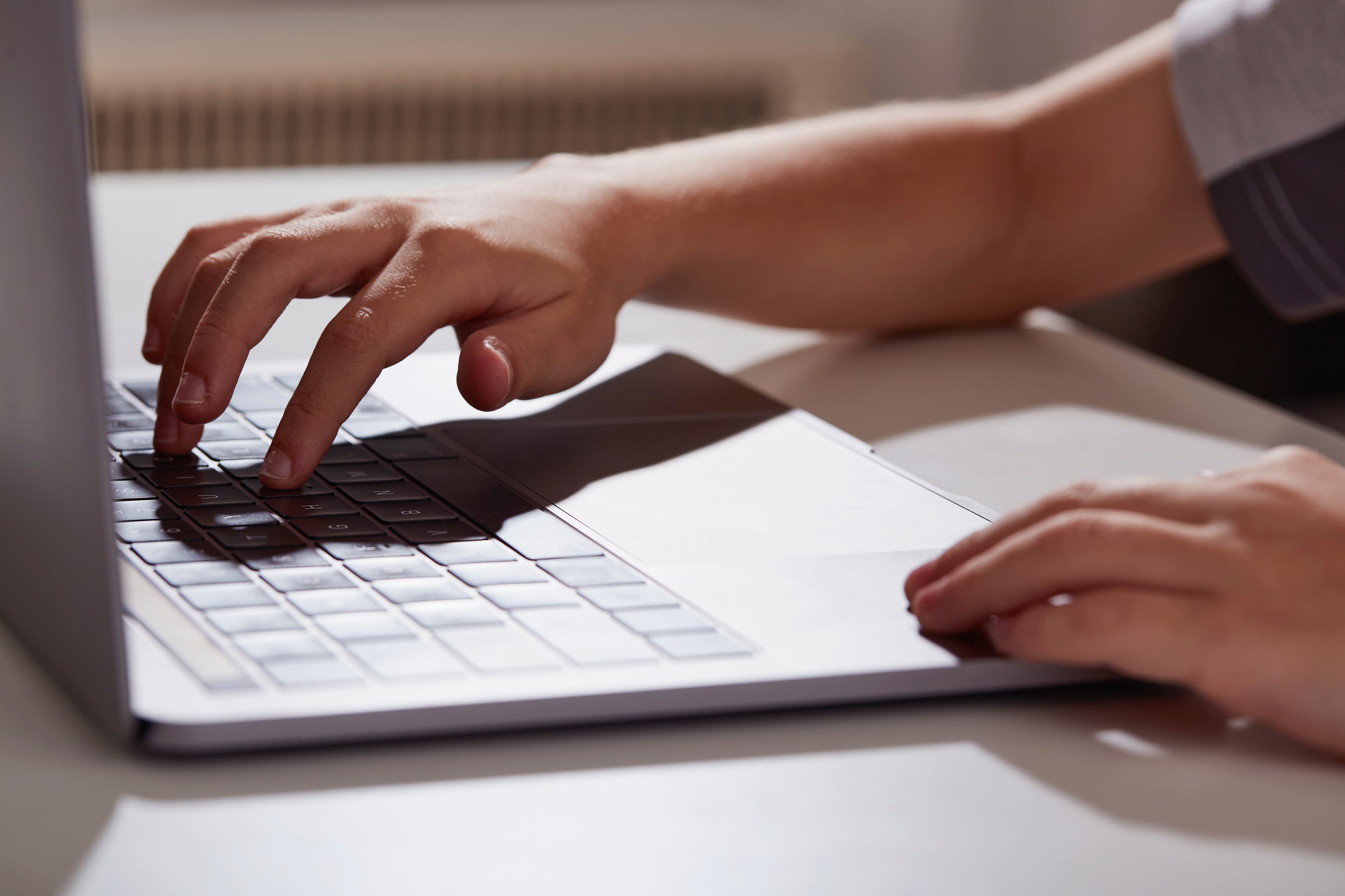 Hands on a computer keyboard.