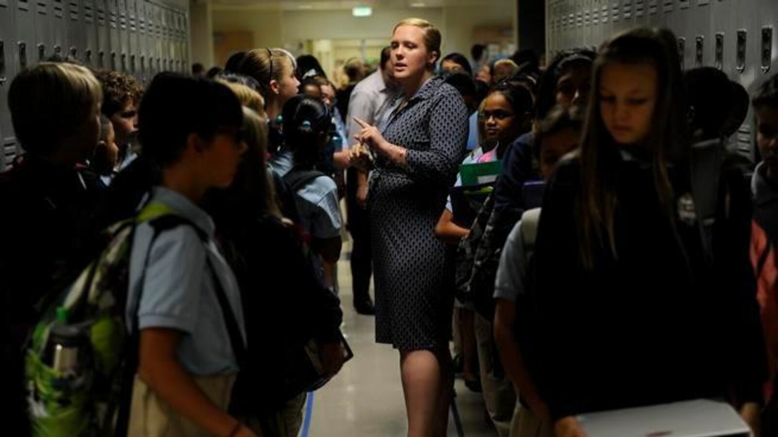 Katie Ethridge talks to her sixth grade science class in the hallway at DSST's Byers campus in 2014. The building reopened after $19 million in renovations paid for through Denver's 2012 bond (Denver Post file).