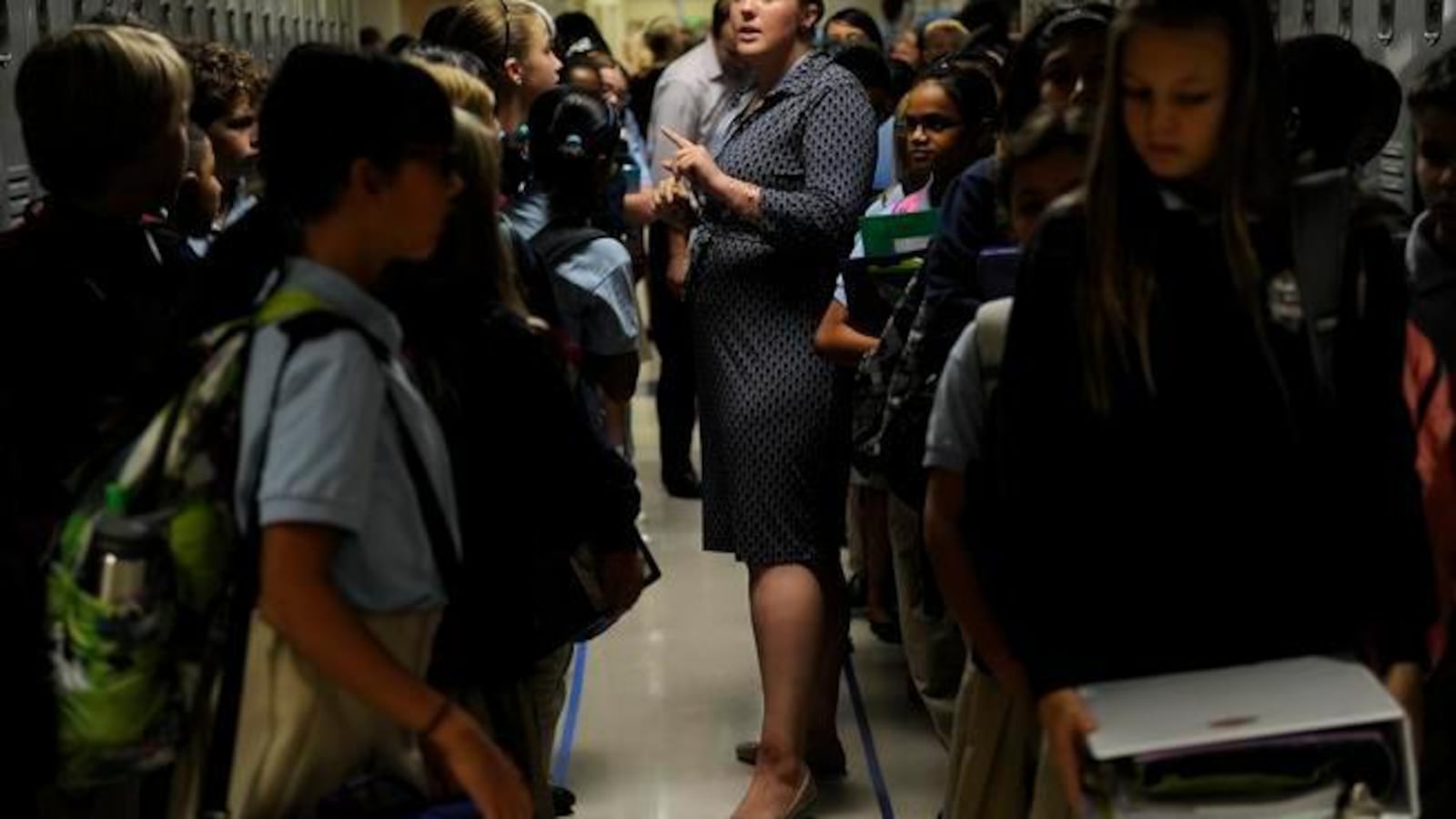 Katie Ethridge talks to her sixth grade science class in the hallway at DSST's Byers campus in 2014. The building reopened after $19 million in renovations paid for through Denver's 2012 bond (Denver Post file).