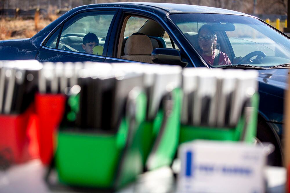 Kylie Dennison drives up to Joe Shoemaker School to get a laptop for her son as Denver students prepare for remote learning in March.