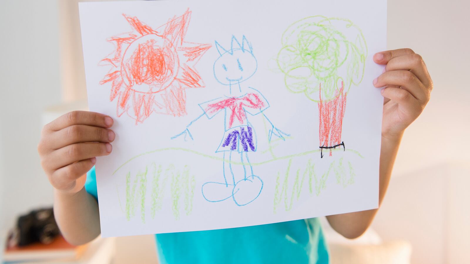 Boy displaying drawing.