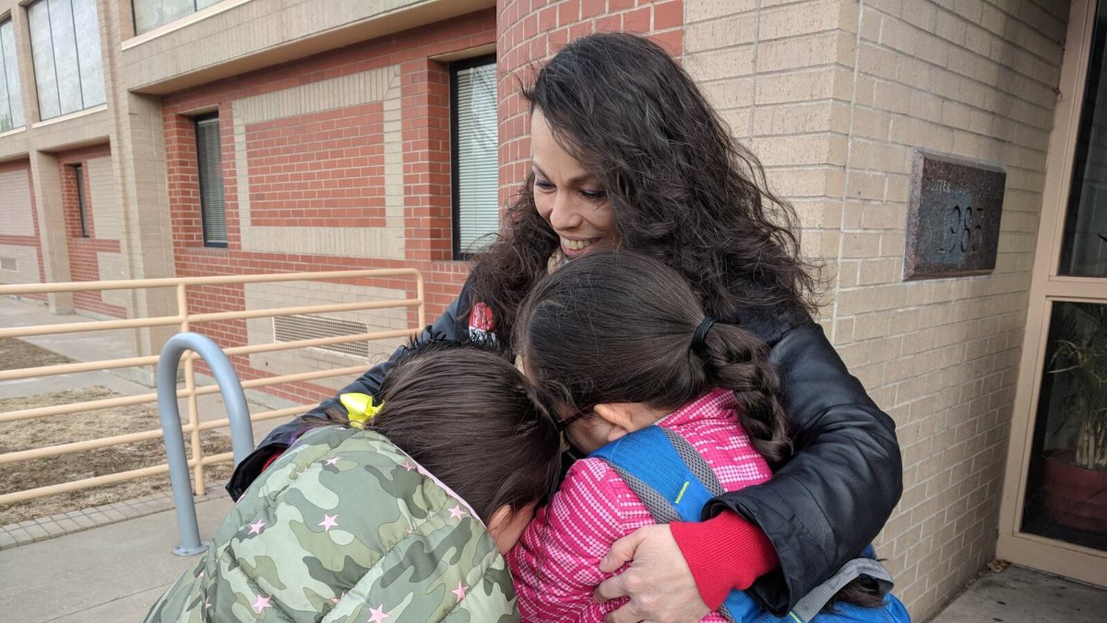 Lupe Lopez-Montoya greets students at Columbian Elementary School on Thursday after Denver's three-day teacher strike.